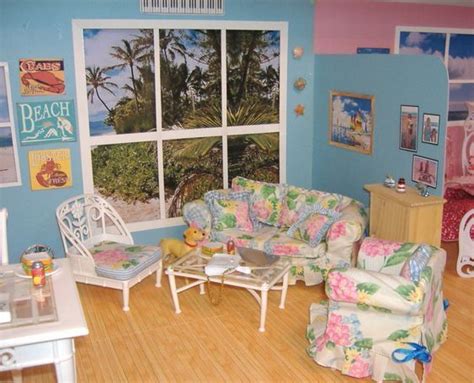 a doll house living room with furniture and pictures on the wall behind ...