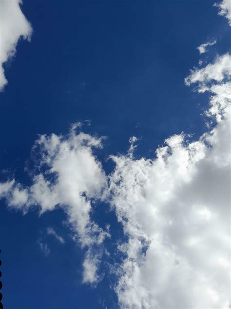 White clouds in the blue sky. Beautiful bright blue background. Light ...