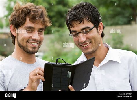 Afghan students using a solar powered tablet Stock Photo - Alamy