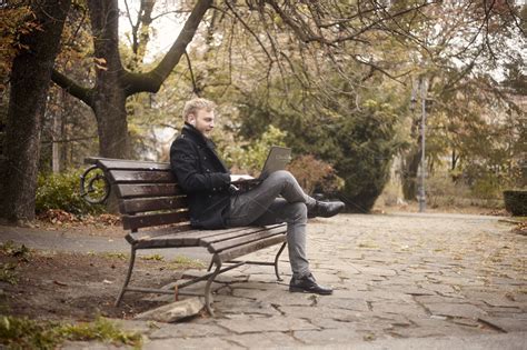 one young man, sitting on bench in p | People Images ~ Creative Market