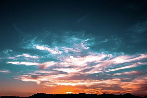 Light from the setting sun illuminating the sky and clouds Photograph by Artpics - Pixels