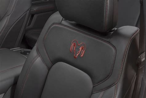 Premium black Katzkin leather seats in the front and back carry Rebel red Ram’s Head logos on ...