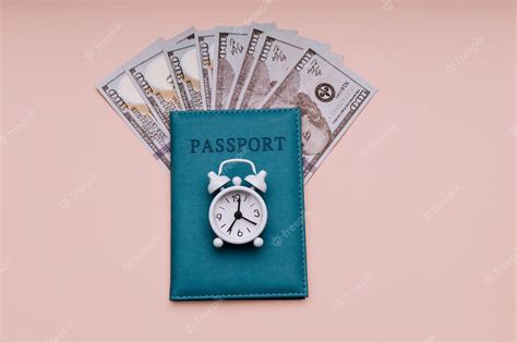 Premium Photo | Passport and white alarm clock with dollar banknotes