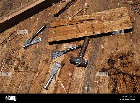 Caulking irons, caulking mallet and hemp fiber (oakum) are seen on the board of a traditional ...