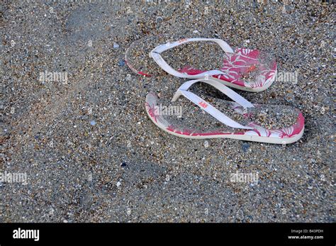 pair of pink flip flops left on the beach Stock Photo - Alamy