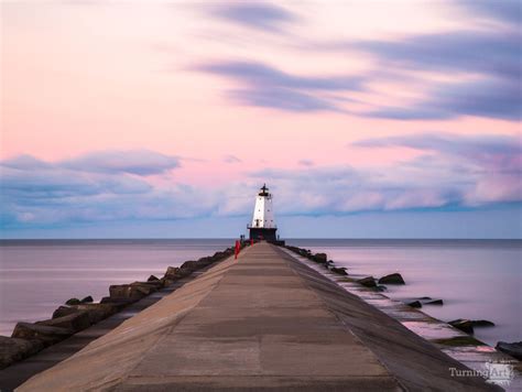 Ludington North Breakwater Light Sunrise by Adam Romanowicz - TurningArt