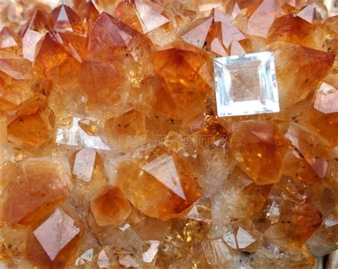 Cut and Polished Topaz on a Bed of Citrine Crystals Stock Photo - Image of orange, citrine ...