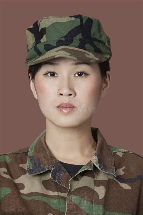 Portrait Of Beautiful Young US Marine Corps Soldier In Camouflage Clothing Over Brown Background ...