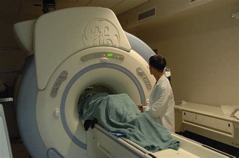 MRI machine with patient | Description: Technician checks MR… | Flickr