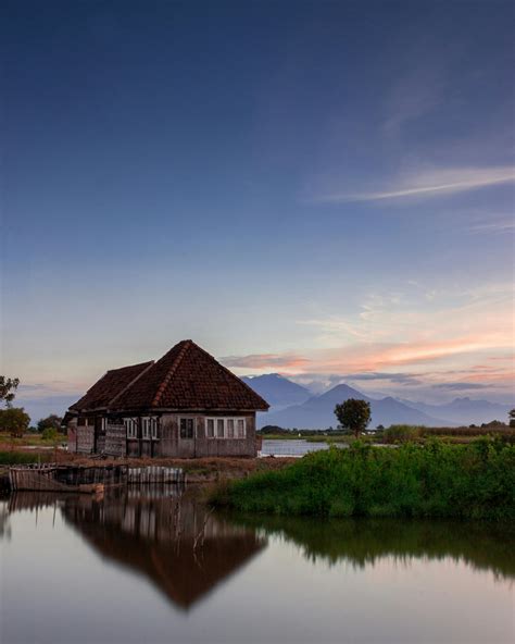 Stilt Houses in a Mountain Lake at Sunset · Free Stock Photo