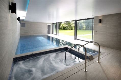 Simple Modern Indoor Pool and Hot Tub with Wall of Windows