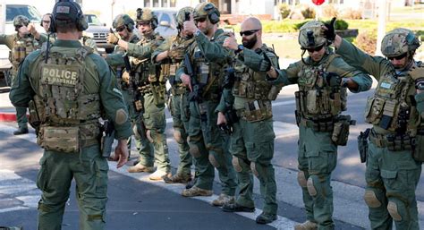 some soldiers are standing on the side of the road and pointing at ...