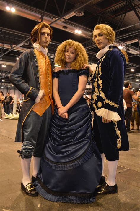 two men and a woman dressed in period costumes