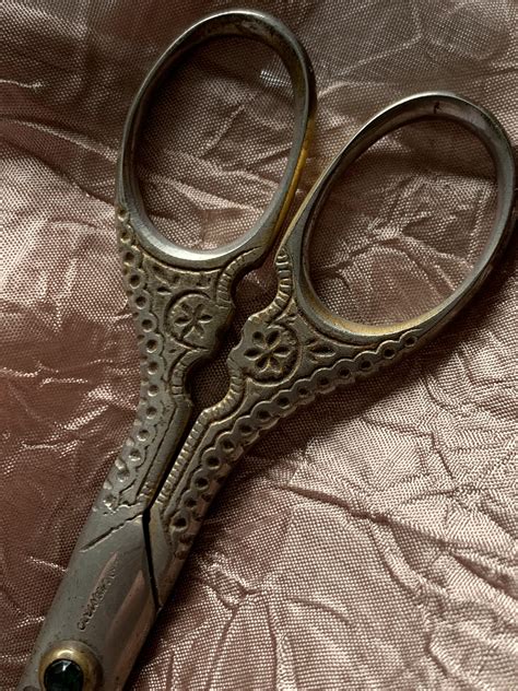 Found these lovely antique fabric scissors that still cut very well! I wish I could make out the ...