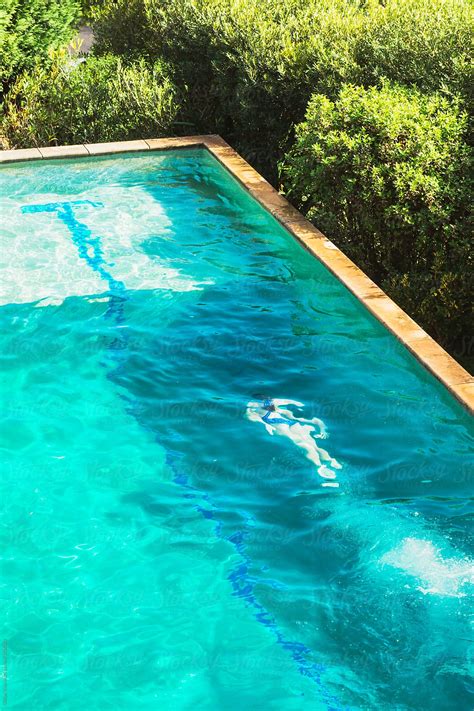 "Overhead View Of Teenage Girl Swimming In A Backyard Pool" by Stocksy Contributor "Gillian Vann ...