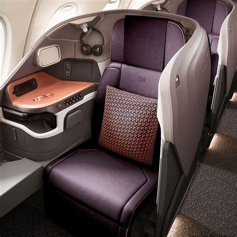 the inside of an airplane with purple seats