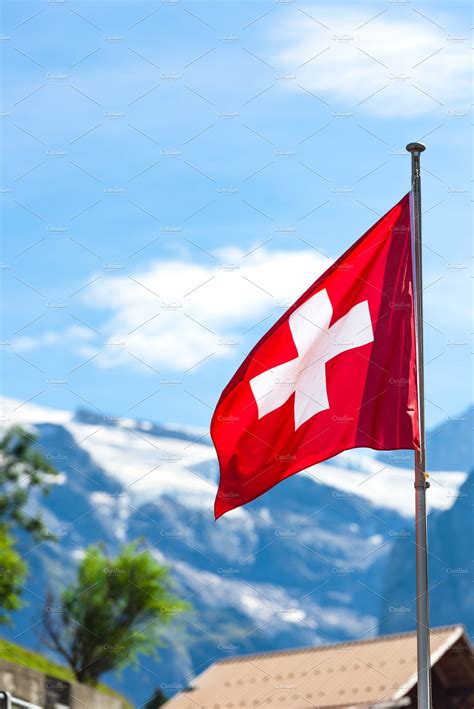 Swiss flag against Alps mountains | High-Quality Nature Stock Photos ...