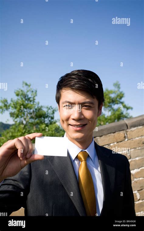Businessman holding a name card on the Great Wall Stock Photo - Alamy