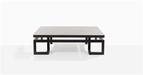 a black and white coffee table sitting on top of a white floor