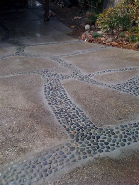 A creative, low cost way to deal with a cracking driveway. First you widen the cracks a little ...