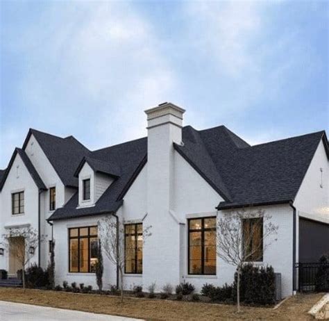 a white house with black roof and windows