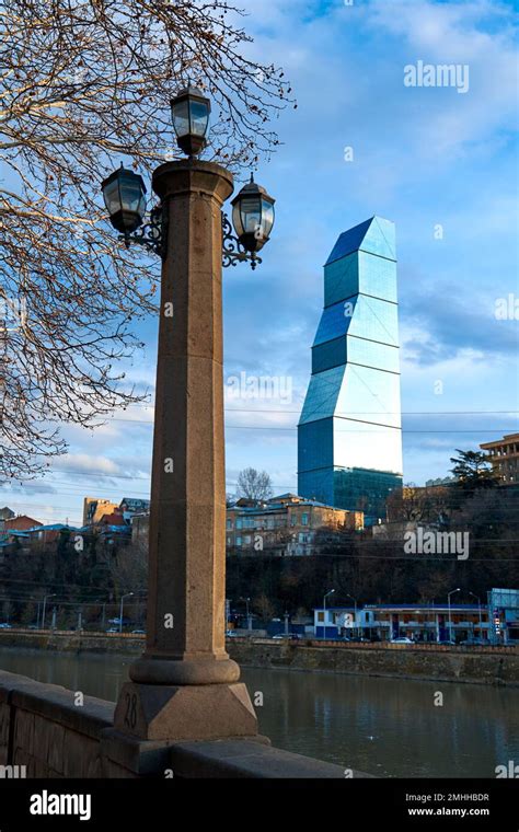 Modern new architecture in the old city of Tbilisi. An old lamppost ...