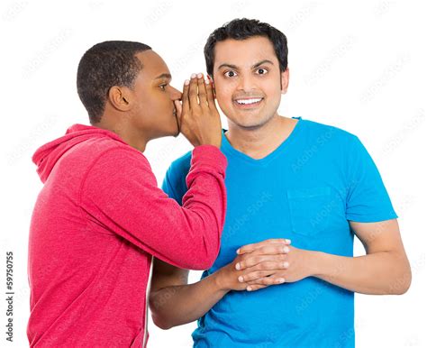 Guy whispering into man's ear telling him something secret Stock Photo ...