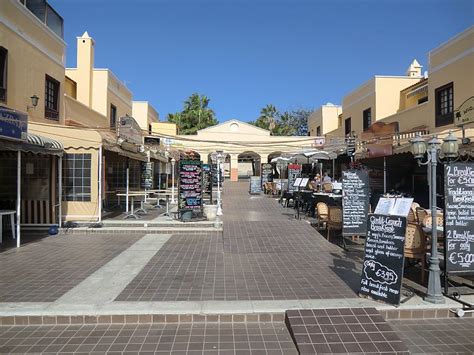 an outdoor market area with tables and chairs