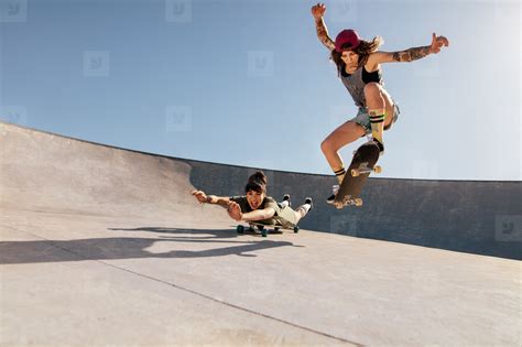 Female skaters doing stunts at skate park stock photo (142565 ...