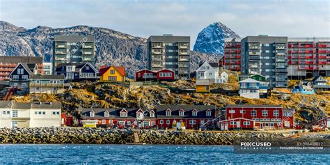 Colourful houses along the rocky shore of Nuuk; Nuuk, Sermersooq ...