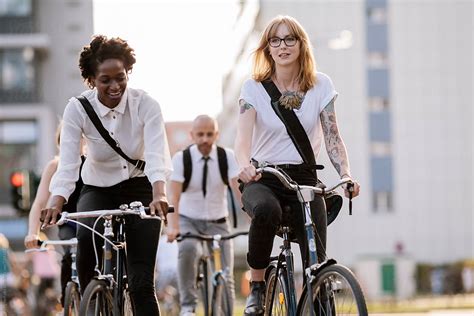 "Three Office Workers Commuting On Bicycles" by Stocksy Contributor "VegterFoto" - Stocksy