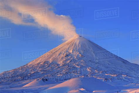 View of eruption active Klyuchevskoy Volcano at sunrise. Eurasia, Russia, Far East, Kamchatsky ...