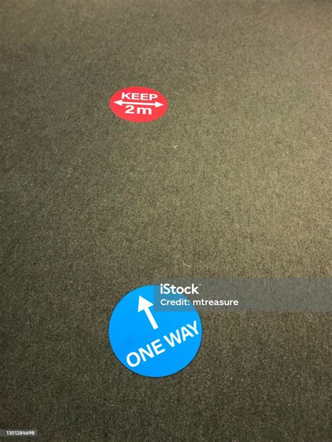 Image Of Circular Stickers On Cement Floor Directional Sign Coronavirus Social Distancing ...