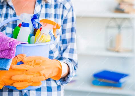 Premium Photo | Janitor holding cleaning equipments in bucket