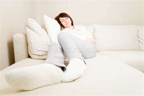 Nap on a couch stock photo. Image of doze, comfort, feet - 9285248