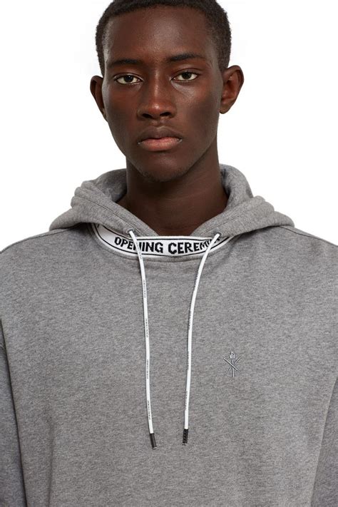 Opening Ceremony banded short sleeve hoodie in heather grey. A sporty drawstring hood and an ...
