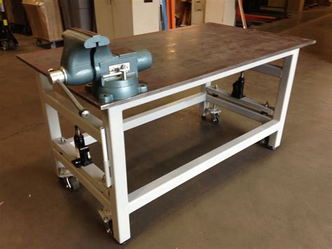 Workbench with retractable wheels - a pair of hydraulic jacks and some heavy duty casters ...