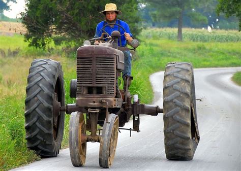 Amish man driving a tractor | I thought the Amish threw off … | Flickr | Amish, Amish community ...