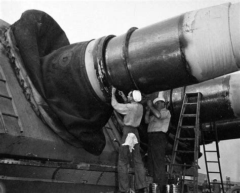 Iowa-class battleship USS New Jersey (BB-62) crewman check the packing ...