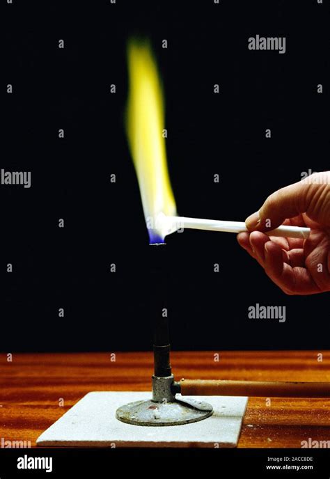 Flame test on sodium. Sodium compounds give a distinctive yellow colour ...