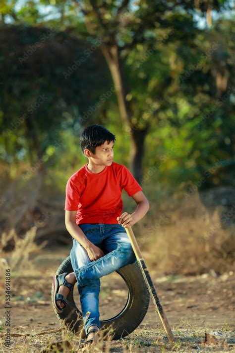 Rural Indian Child Playing Cricket Stock Photo | Adobe Stock