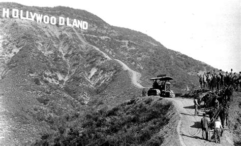 The Hollywoodland sign and tractor and cheering workmen, 1923