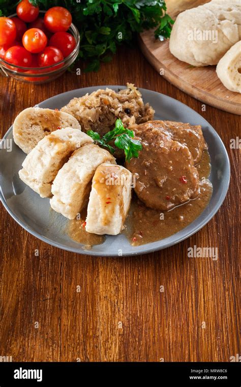 Pork loin in gravy with bread dumplings and sauerkraut. Czech cuisine ...