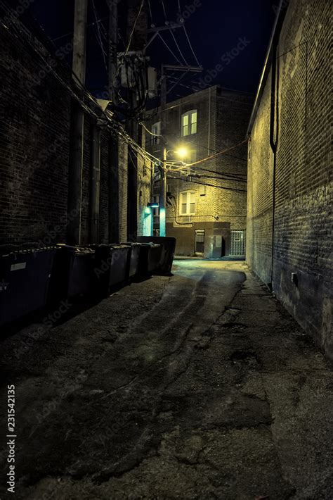 Dark and scary downtown urban city street corner alley with an eerie ...