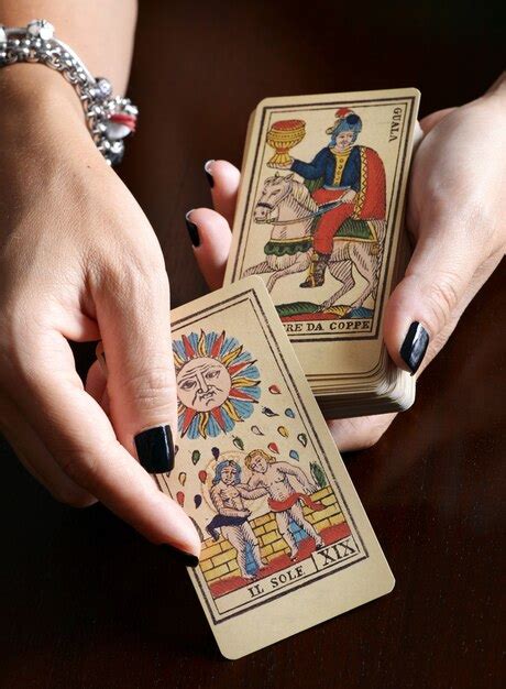 Premium Photo | Fortune teller showing vintage tarot cards