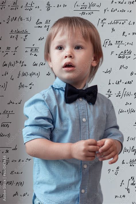 Portrait of the little boy in the blue shirt over the math background ...