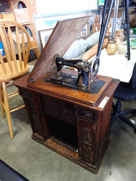 VINTAGE TREADLE BASE SINGER SEWING MACHINE IN CARVED CABINET