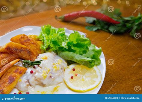 Lemon Baked Haddock with Fried Potatoes. Lemon Sause, Stock Photo - Image of olive, potatoes ...