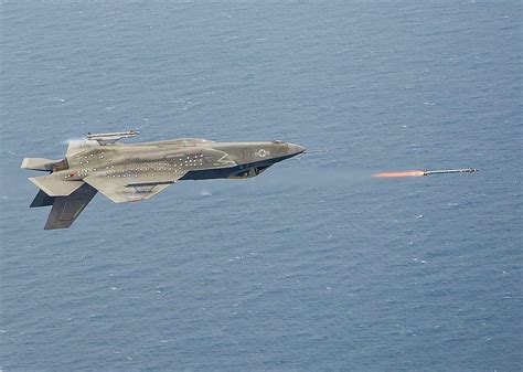 US Navy F-35C Lightning II firing an AIM-9X during inverted flight. Patuxent River Naval Base ...