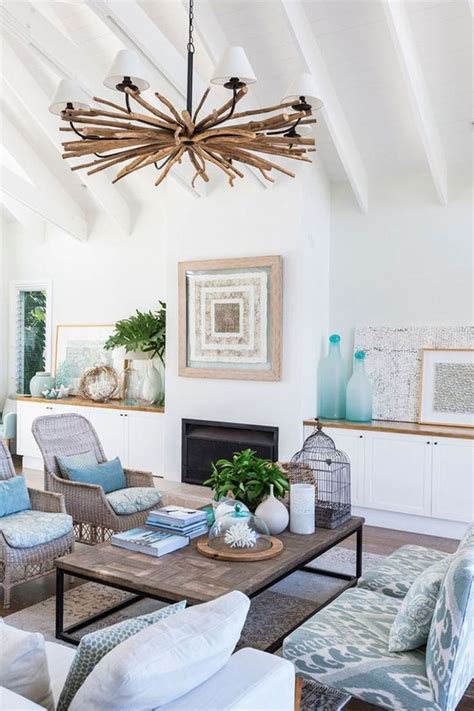 a living room filled with furniture and a large chandelier above the ...